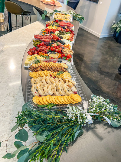 Custom Grazing table by Meat & Graze in Durham, NC with greenery
